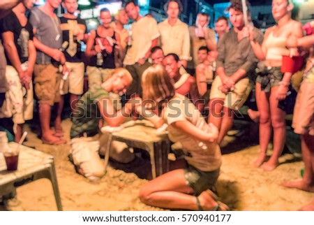 Blur background of People arm-wrestle activity in Full moon party at Phangan Island,  Thailand, Hang over in Thailand, breaker activities game ,  team building 