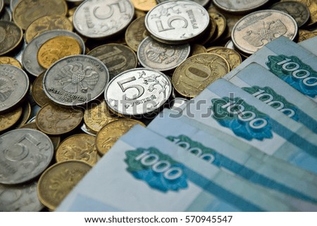 one-thousand rubles banknotes on coins background. russian money for backgrounds and illustrations