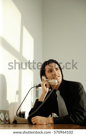 Executive at desk, on the phone