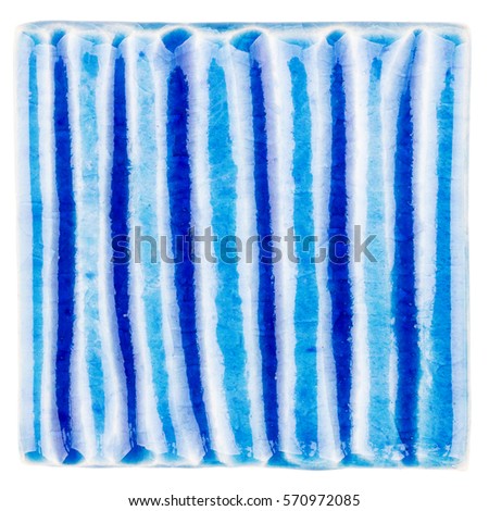 Blue lined handmade glazed ceramic tile isolated on white background