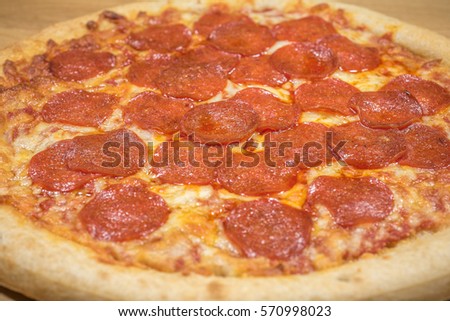 Pepperoni Pizza Up Close Studio Shot against a wooden background