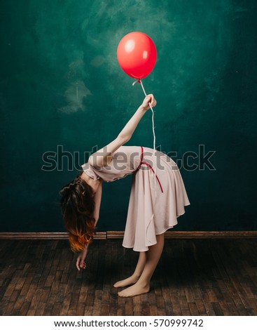  woman with a red balloon in hand.