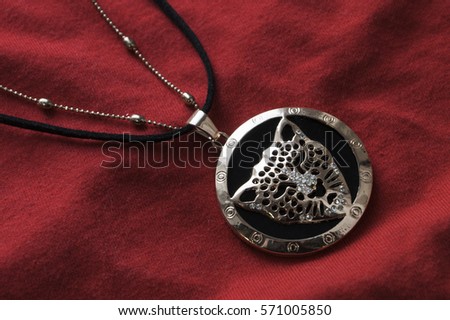 Jewelry chain in the form of a tiger on a red background