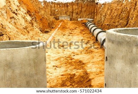 Construction of the well for sewerage Royalty-Free Stock Photo #571022434
