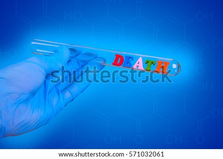 Word death of colored wooden letters in test-tube. Hand in glove holding a test tube on a blue background