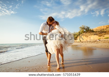 Sea travel, happy couple hugging on sea side near hot summer water of ocean. Honeymoon picture