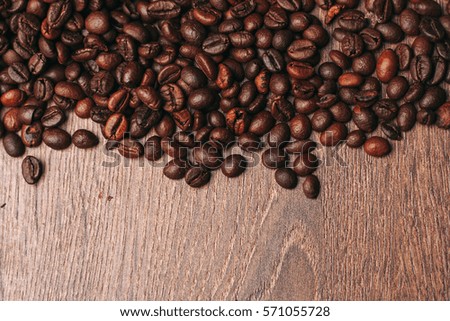Roasted coffee beans scattered on the table.