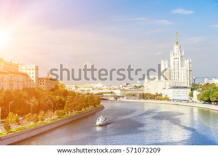 Kotelnicheskaya embankment with leisure boat floating across the Moscow river on a sunny day