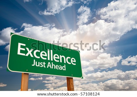 Excellence Just Ahead Green Road Sign with Dramatic Clouds, Sun Rays and Sky.