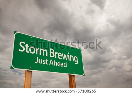Storm Brewing Just Ahead Green Road Sign with Dramatic Storm Clouds and Sky.