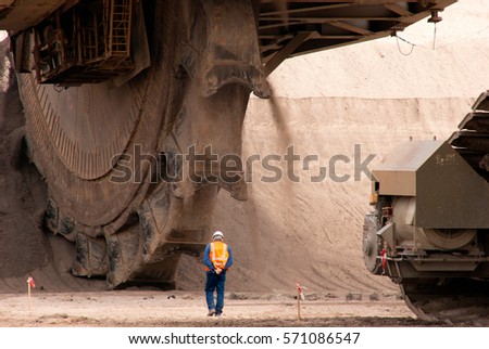 The large wheel of a bucket wheel excavator in a lignite quarry, Germany Royalty-Free Stock Photo #571086547