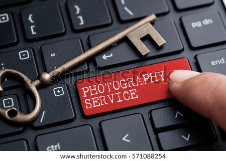 Closed up finger on keyboard with word PHOTOGRAPHY SERVICE