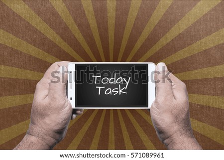 Hand of man holding mobile (or smart phone) with text "Today Task".