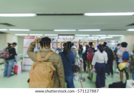 Blurred defocused image of travellers queue at immigration control at airport, for background, color tone effect.