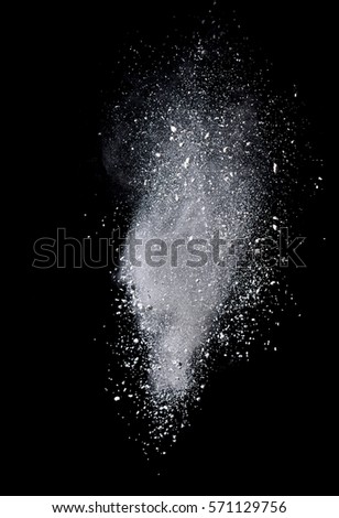 An explosion of colored powder. Beautiful powder fly away. The cloud of glowing color powder on black background