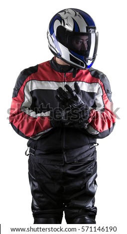 Man wearing a protective leather and textile racing suit for racers and motorcycle motor sports.  The gear is armored with a helmet and worn by bikers and professional race car drivers. Royalty-Free Stock Photo #571146190