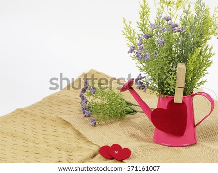 love concept. flower in pink pot with red heart on sack fabric