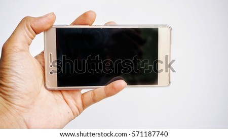 Conceptual image cropped hand holding mobile phone on white background