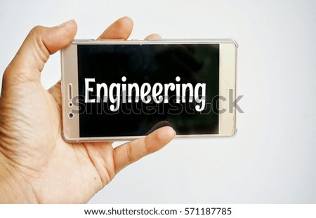 Conceptual image cropped hand holding mobile phone with text on white background