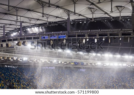 against the background of a sports stadium floodlights, flying snow