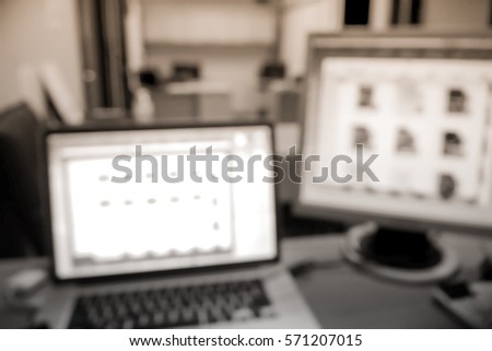 Picture blurred  for background abstract and can be illustration to article of Computer and laptop on the working place in the office