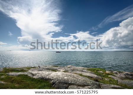 Seascape from a Helsinki shore on a beautiful summer day Royalty-Free Stock Photo #571225795
