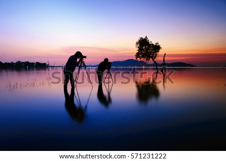 Photographers, silhouette of two photographers and sunset 