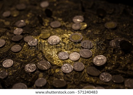 Close up coins on Buddha's Footprint 