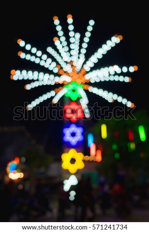 Abstract blur and bokeh of lights at temple in Thailand. Ferris wheel Lights blurred, background.
