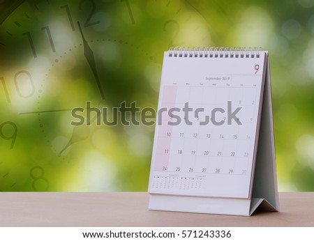 September Calendar 2017 with Clock Screen on wood table with Beautiful Nature Bokeh.Blurred background