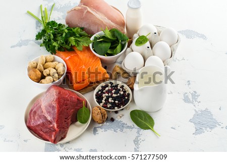 High protein food - fish, meat, poultry, nuts, eggs. Products goof for healthy hair. Space for text Royalty-Free Stock Photo #571277509