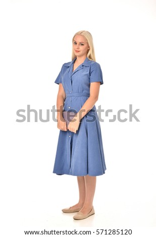 full length portrait of a blonde haired woman wearing a simple blue dress.
standing pose  isolated on white background.
