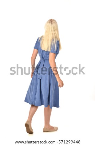 full length portrait of a blonde haired woman wearing a simple blue dress.
standing pose  isolated on white background Royalty-Free Stock Photo #571299448