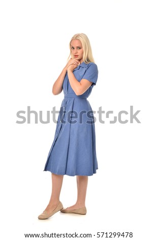 full length portrait of a blonde haired woman wearing a simple blue dress.
standing pose  isolated on white background