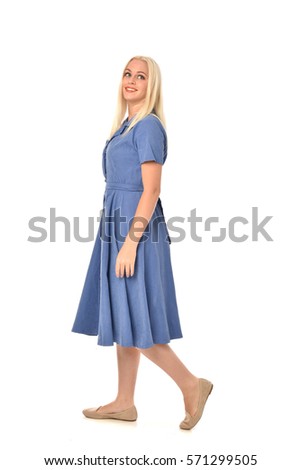full length portrait of a blonde haired woman wearing a simple blue dress.
standing pose  isolated on white background