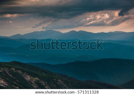 Sunset over layers of mountains.