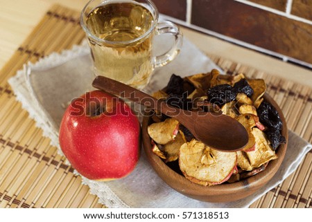 Compote of dried fruits and fresh apples on a background of a brick wall. Top view. Selective focus.