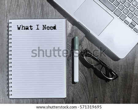 What I Need, Typed Words On a handbook with note book, marker pen and notebook. Vintage and classic background mood with noise.