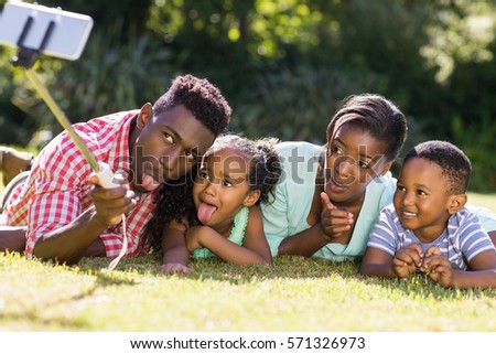 Happy family taking picture at park