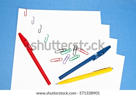office supplies - colored paper clips and pens