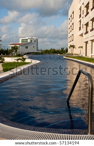 Steps Leading into a Dark Blue Tropical Pool at a Resort