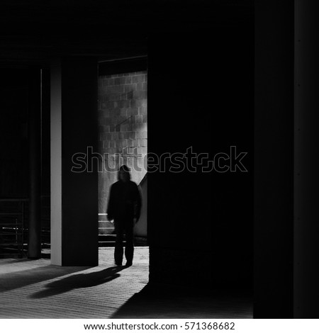 Lonely man walking through night city scenery