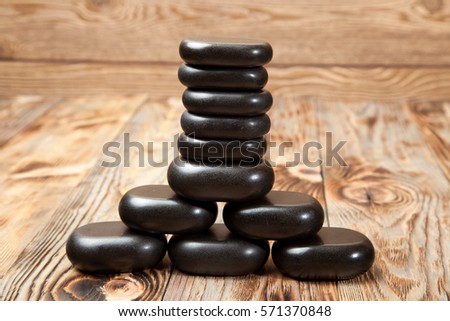 Spa stones in te wooden background.
