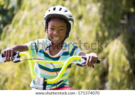 A sporty kid bike riding on a park