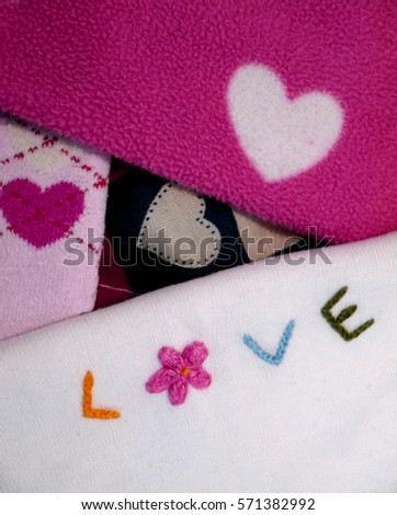 Hand embroidery. Embroidered multicolored letters and a flower. Hearts on fabrics. Word: Love. The inscription: I love you. Postcard congratulation confession. happy Valentine's Day. Background