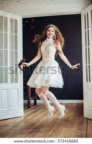 Fashion photo of happy jumping girl wearing wedding dress