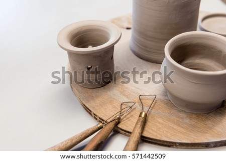 clay pottery appliance on wooden wheel
