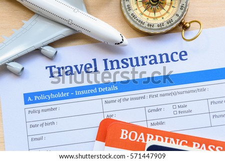 Travel insurance form put on a wood table. Many agent sells airplane tickets or travel packages allow consumers to purchase travel insurance also known as travelers insurance as an added service. Royalty-Free Stock Photo #571447909