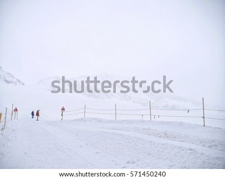 Snow cover walk path and white mountain background in a snowy day  