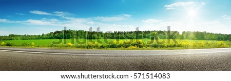 asphalt road panorama in countryside on sunny spring day Royalty-Free Stock Photo #571514083